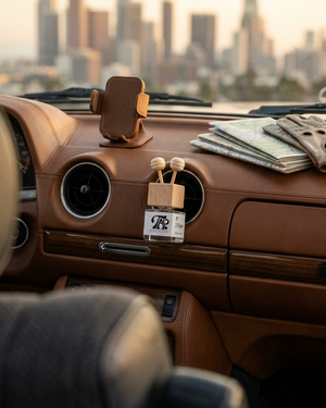 Car interior with dashboard accessories and cityscape view